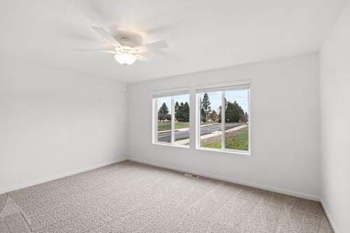 A room with a window showing a street view.