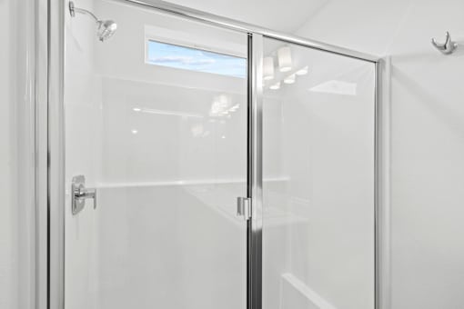 A glass door with a handle and a lock.
