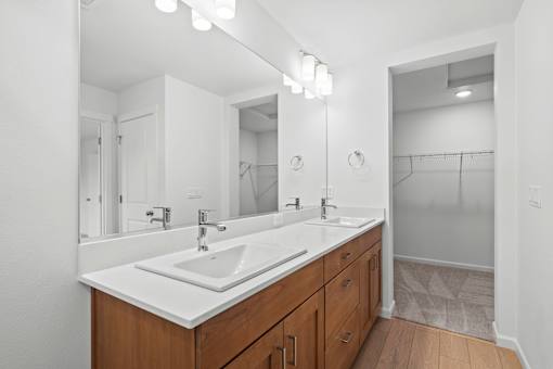 A bathroom with a double sink and a large mirror.