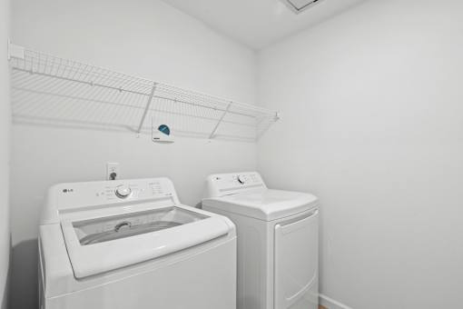 A white dryer and washer in a laundry room.