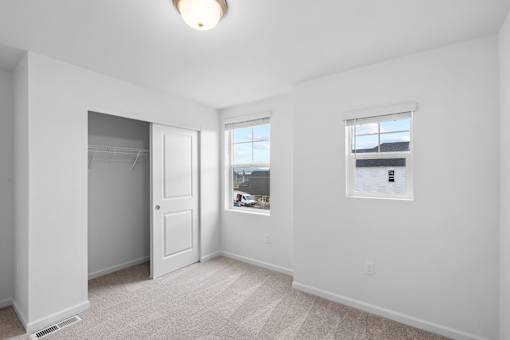 A white room with a window and a door.