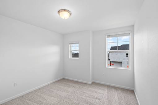 A room with a window and a picture on the wall.
