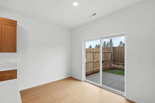 A room with a sliding glass door leading to a backyard.