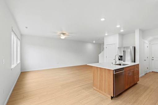 A kitchen with wooden floors and white walls.