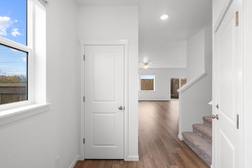 A white door is in the middle of a hallway.