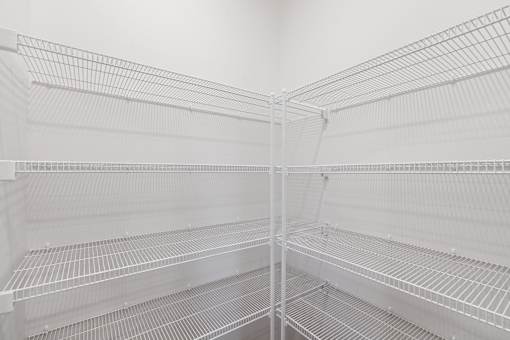 Empty shelves in a white refrigerator.