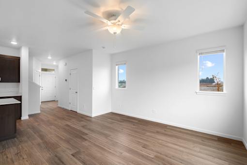 A room with wooden floors and a ceiling fan.