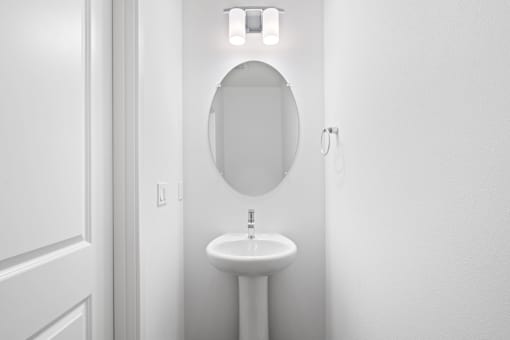 A white sink in a small bathroom.