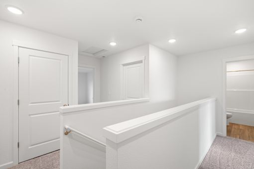 A white room with a door and a window.