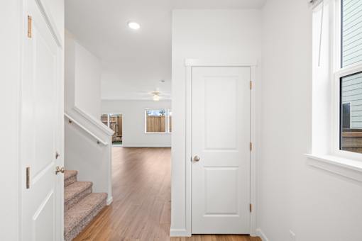 A white door is in the middle of a hallway.