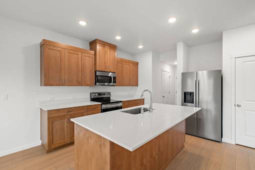 A kitchen with wooden cabinets and a white countertop.