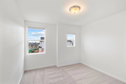 Room with two windows and a carpeted floor.