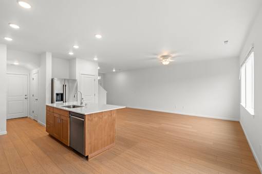 Kitchen with wooden floors and white walls.