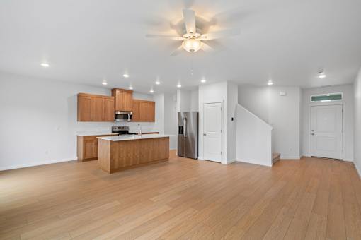 A kitchen with wooden floors and white walls.