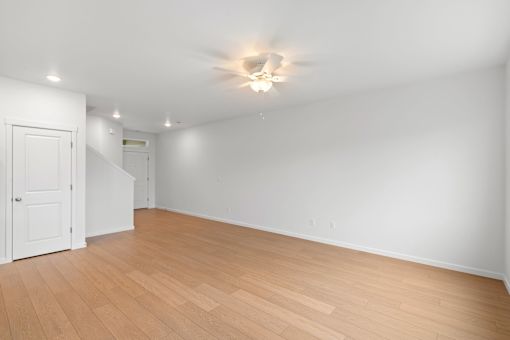 Room with wooden floors and a white door.
