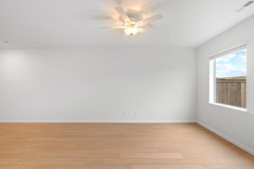 Room with a ceiling fan and a window.