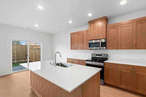 Kitchen with wooden cabinets and a white countertop.