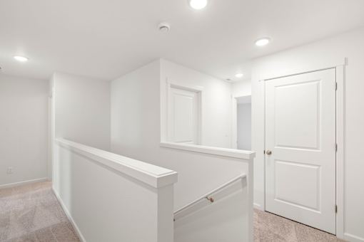 A white room with a door and a window.