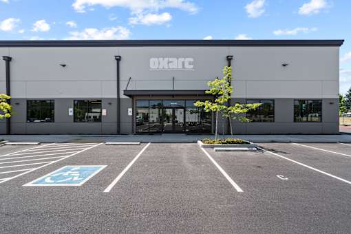 A parking lot in front of a building with the word OKARC on it.