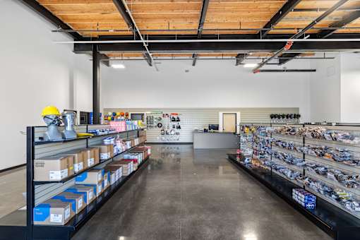 A hardware store with shelves stocked with boxes and tools.