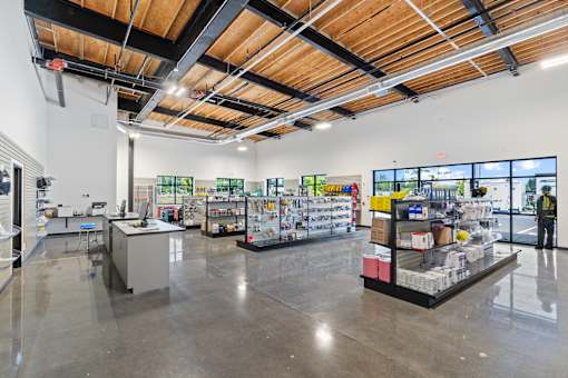 A large, empty warehouse with a variety of items on display.