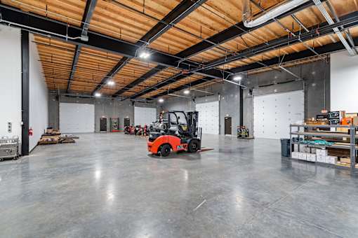 A forklift is parked in a large warehouse.