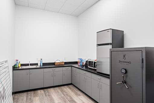 A kitchen with a refrigerator and cabinets.