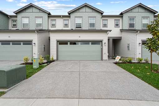 A row of houses with garages in front.