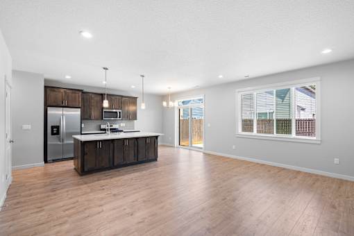 LVP Floors Throughout Open Concept Kitchen Dining Living Area