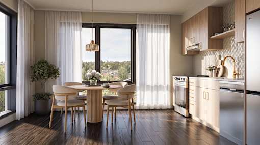 A modern kitchen with a dining table and chairs.