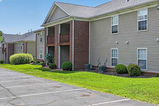 A building with a parking lot in front.
