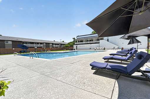 Swimming pool at Renaissance at Carol Stream featuring sun loungers and the building in the background in Carol Stream, IL.