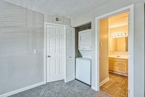 A white door is open to a bathroom.