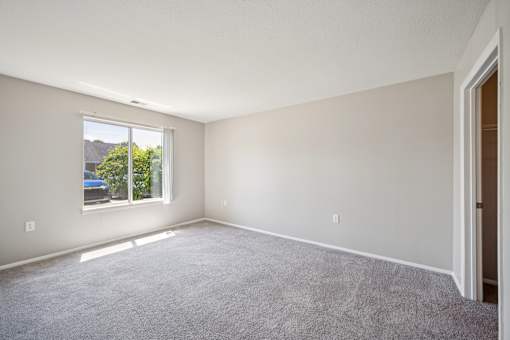 A room with a car parked outside the window.