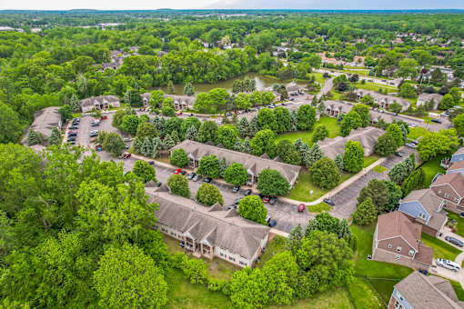 A bird's eye view of a residential area with houses and trees.