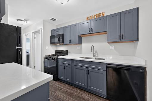 Kitchen at Renaissance at Carol Stream featuring a black refrigerator and matching cabinets in Carol Stream, IL.