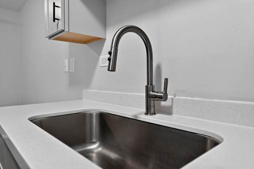 Kitchen sink with chrome faucet at Renaissance at Carol Stream in Carol Stream, IL.