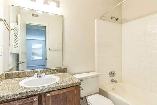 Full bathroom with tub at Ashford Place Mobile AL