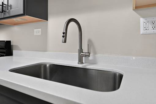 Kitchen sink with chrome faucet at Renaissance at Carol Stream in Carol Stream, IL.