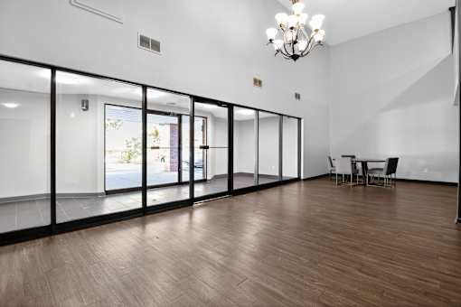 A room with a wooden floor and a chandelier.