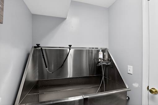 A stainless steel sink in a small room.