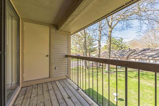 A balcony with a door and a railing.