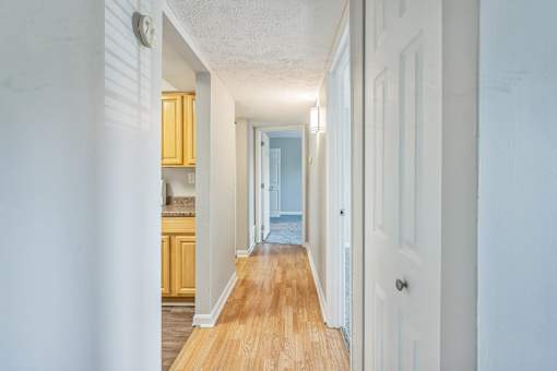 A long hallway with a door on the right.