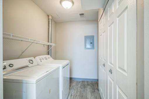 A small laundry room with a washer and dryer.