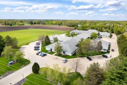 an aerial view of a farm house and parking lot