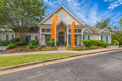 A house with a flag and two orange flags on the front.