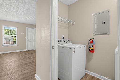 A white washer and dryer in a laundry room.