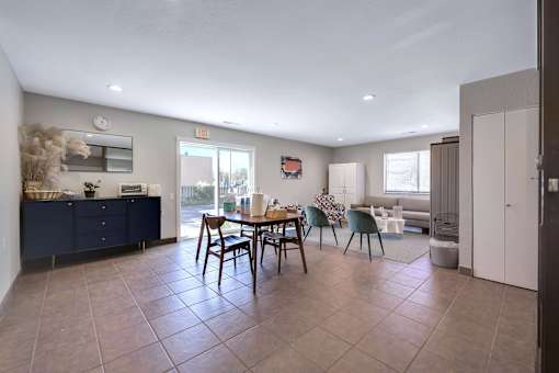 A dining room with a table set for four.