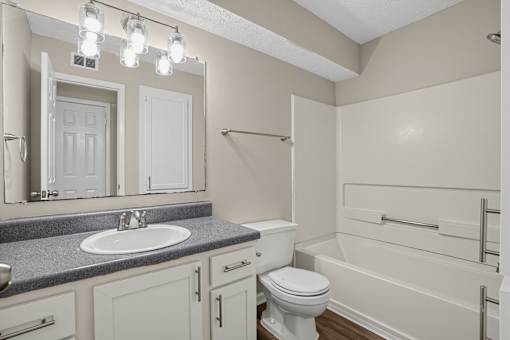 Bathroom with a sink, toilet, and bathtub at Arbours at Victoria Place in Prattville, AL