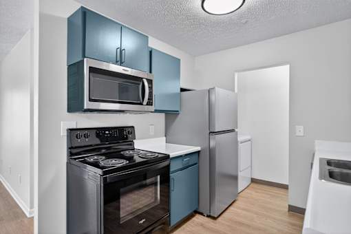 A kitchen with a black stove and a black oven.